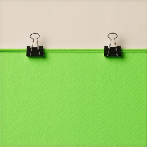 A row of binder clips evenly spaced along a taut green fabric backdrop