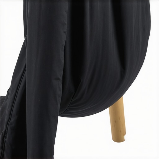 Correct Sandbag Placement for Tripod Stability A black sandbag used to secure a camera tripod leg to prevent camera shake and tipping.